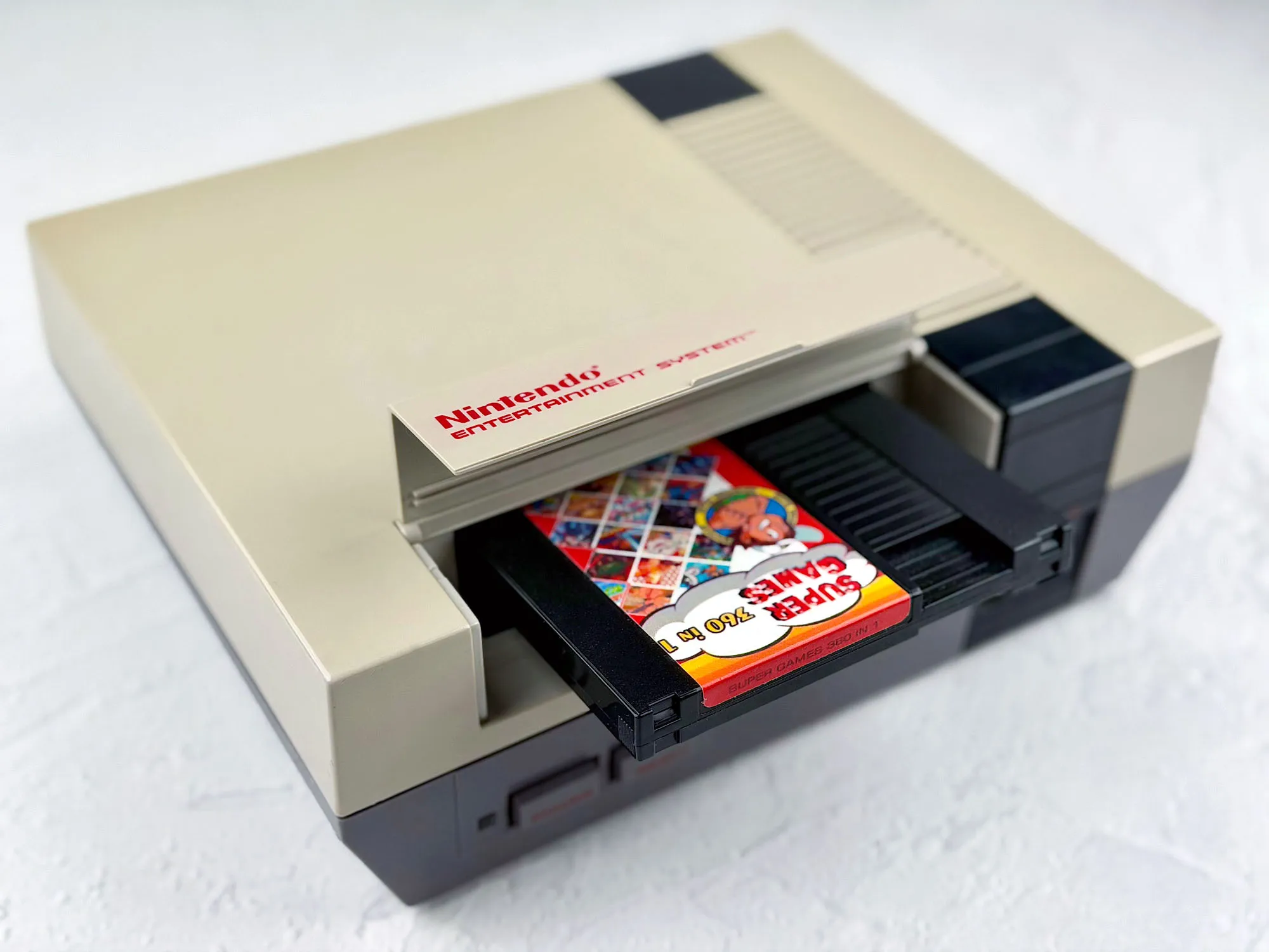 NES cartridge half-inserted into the slot NES cartridge half-inserted into the slot